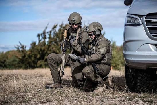 Two soldiers in active headsets during a tactical mission