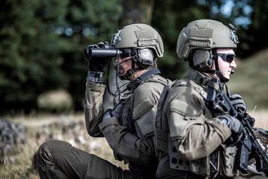 Soldiers wearing 3M Peltor ComTac VIII active headsets look in different directions