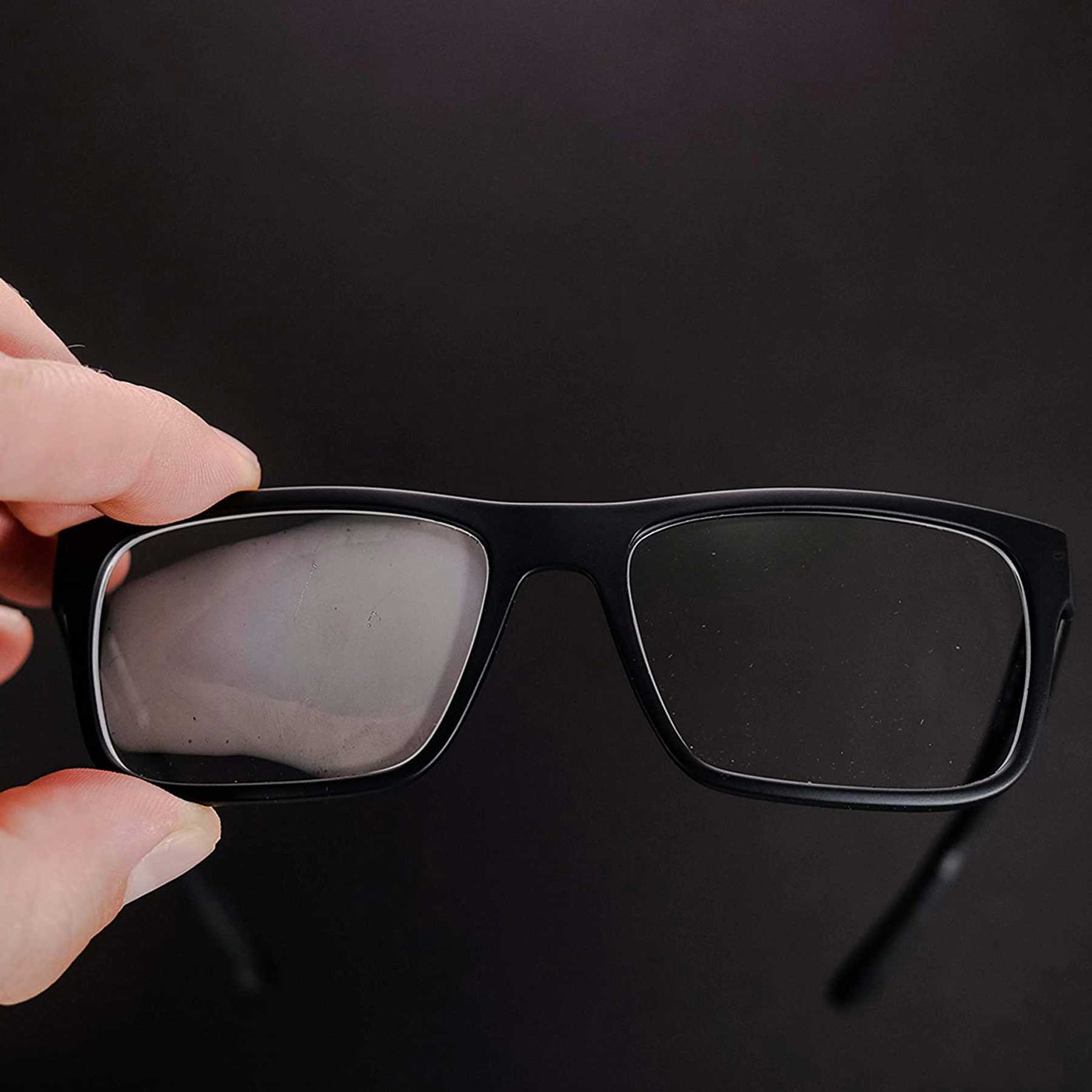 Glasses with a black frame, one lens is fogged, the other is clear