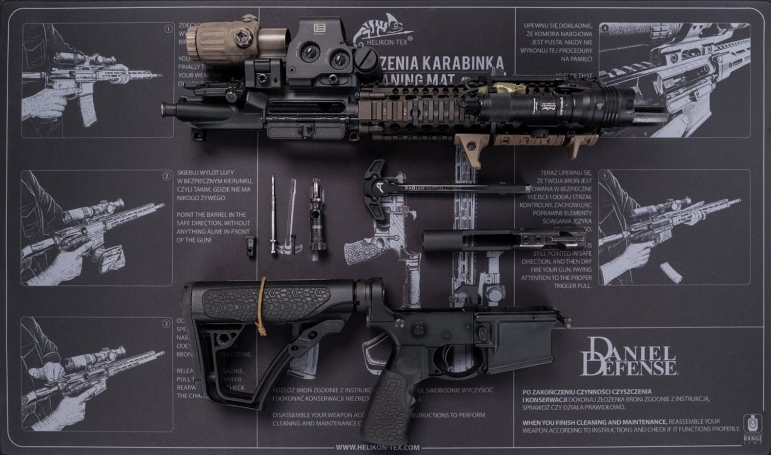 A partially disassembled rifle on a gun-cleaning mat