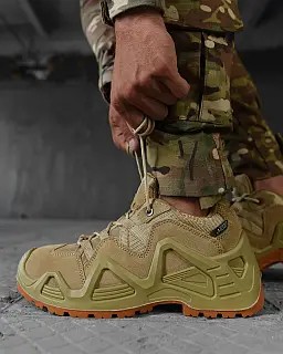 Matching coyote-colored sneakers with camouflage-patterned pants