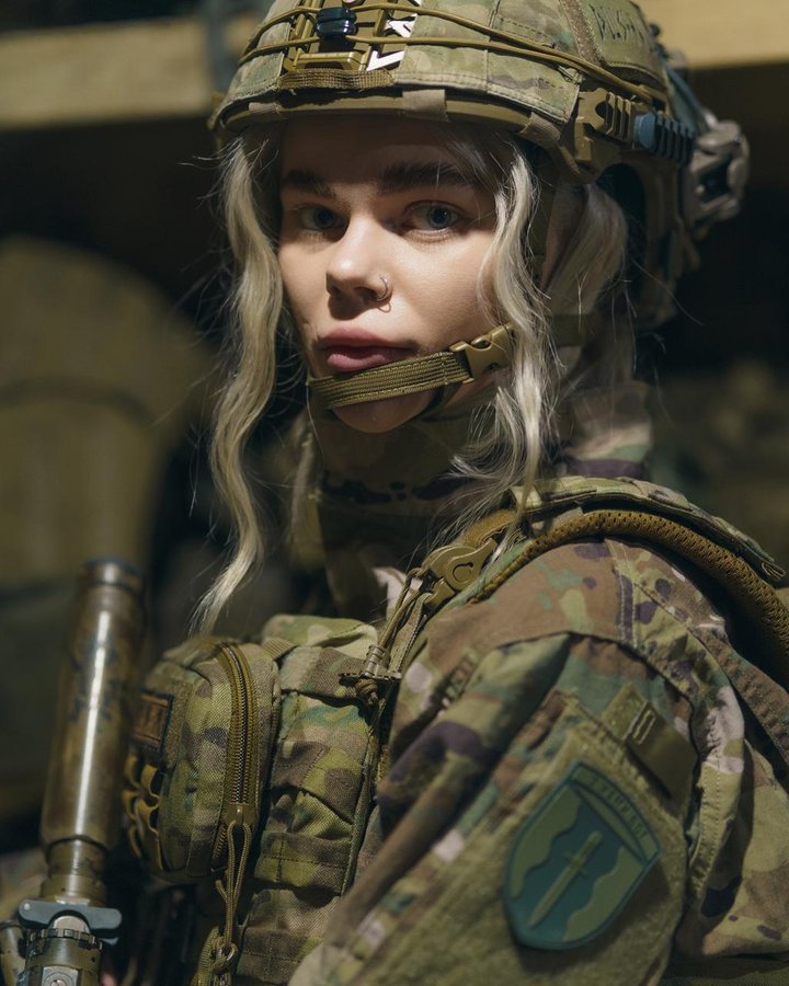 A woman in military clothing and body armor