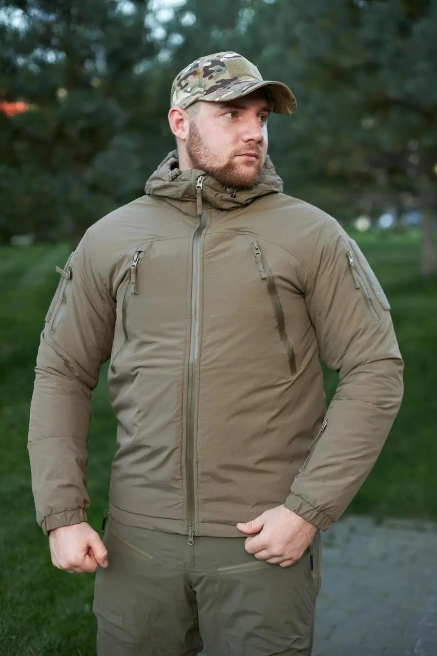 A soldier in a coyote-colored winter jacket