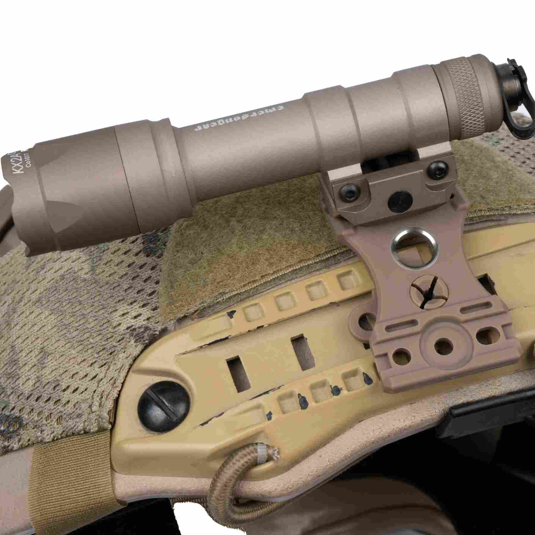 Flashlight mounted on a tan ARC rail of a helmet with a camouflage cover
