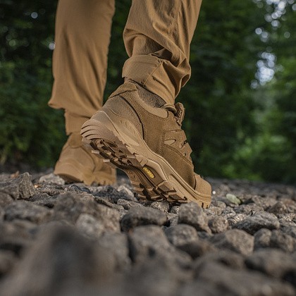 Summer tactical sneakers on rocks