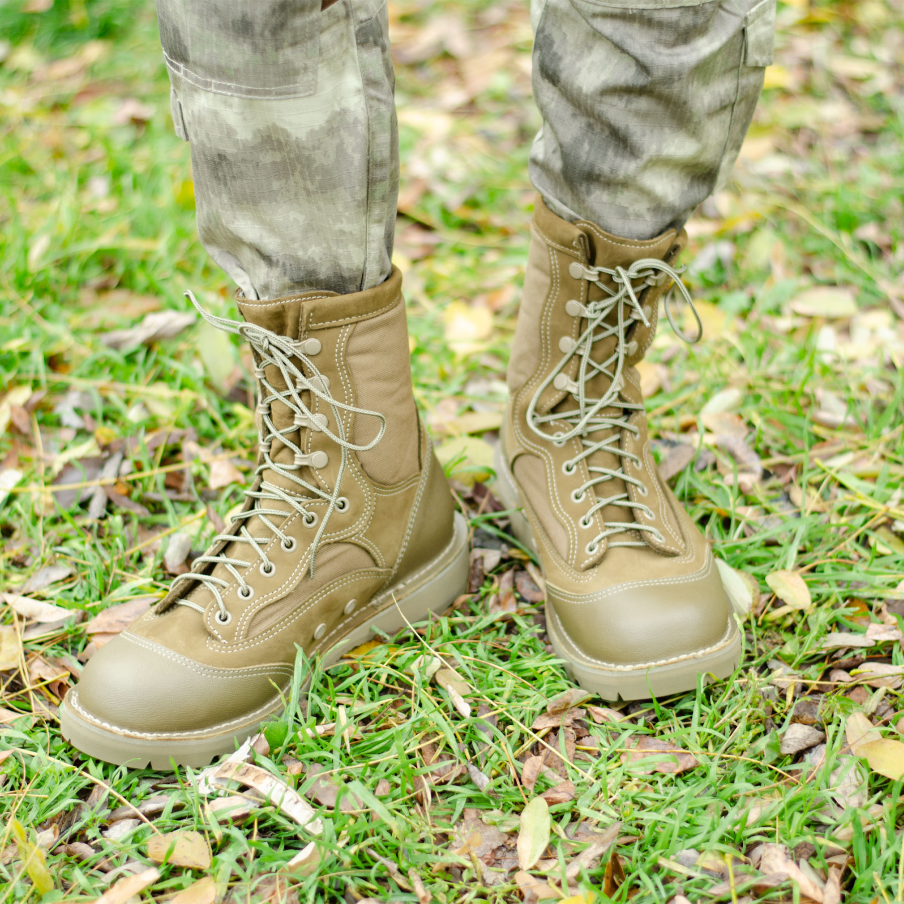 Summer boots on the grass and fallen leaves