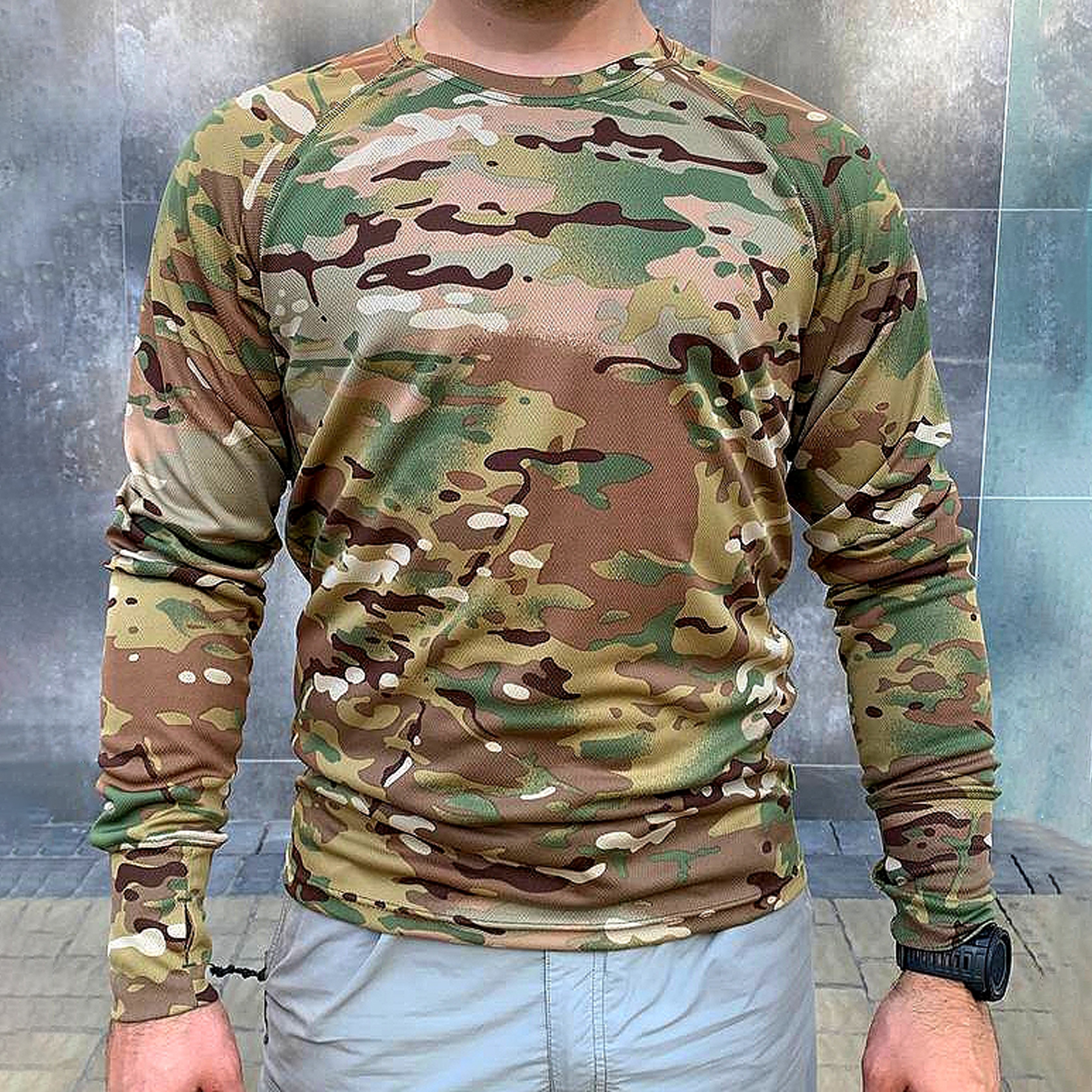 A man wearing a camouflage long-sleeve shirt
