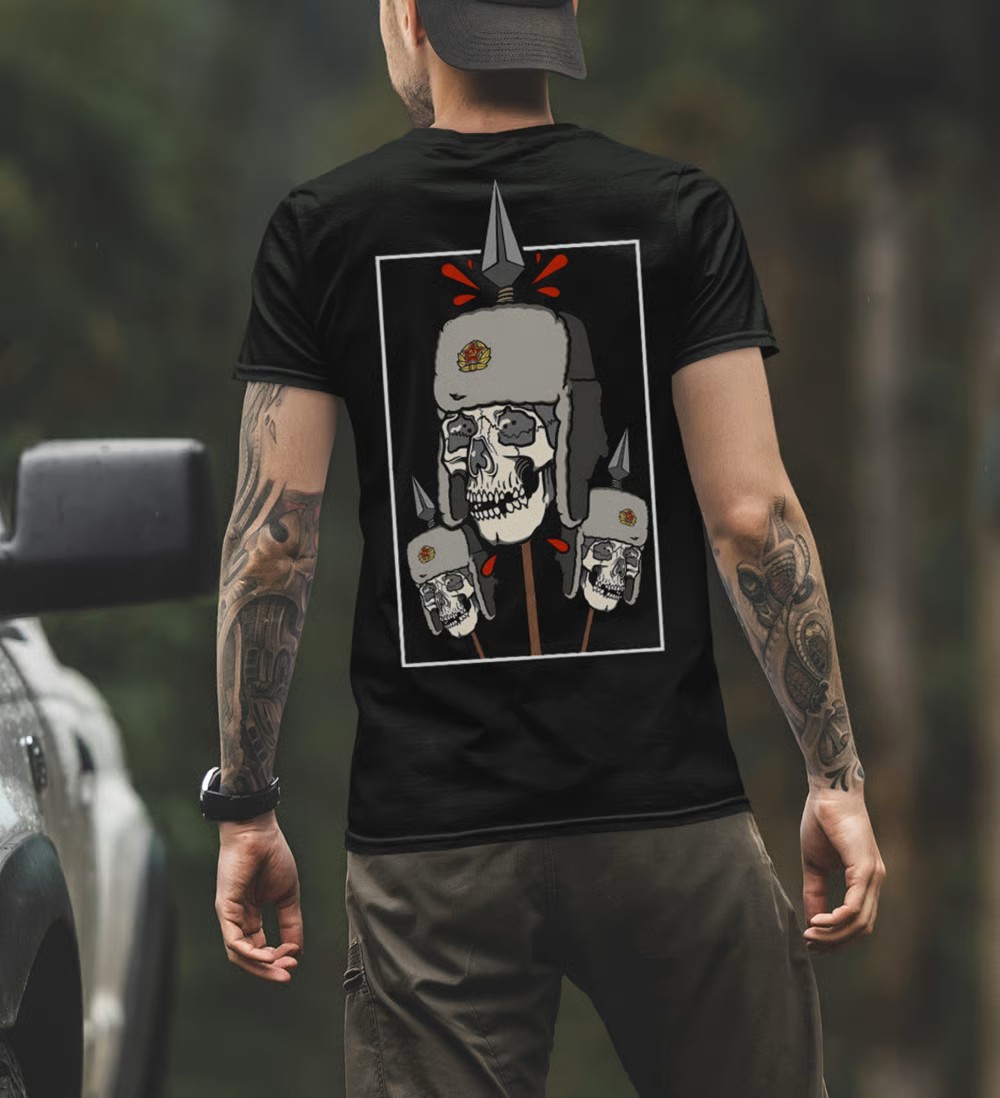 A guy in a black T-shirt with a print of occupiers' skulls impaled on spears