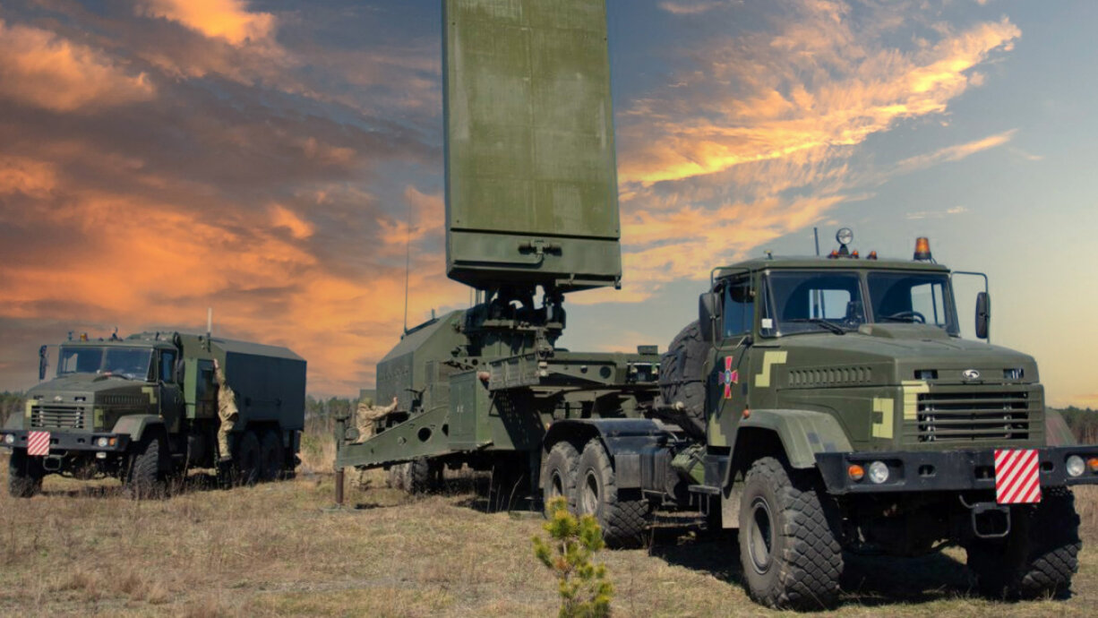 Mobile electronic warfare vehicle on a truck in a field under cloud cover