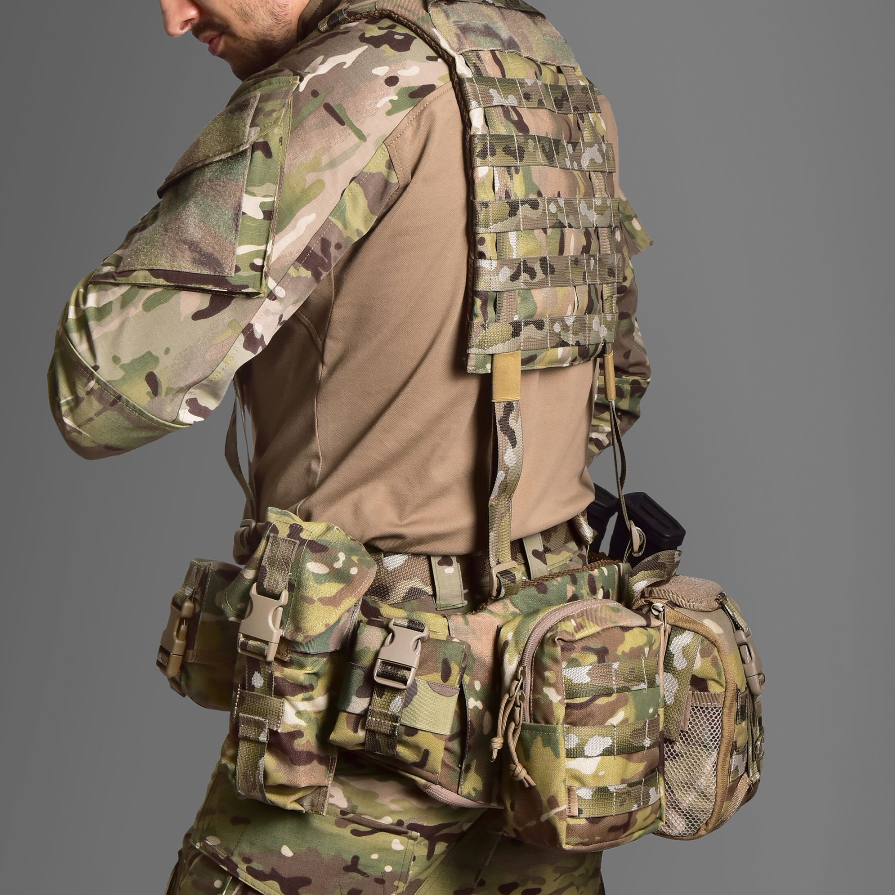Man in Multicam camouflage with pouches on his belt (side view)