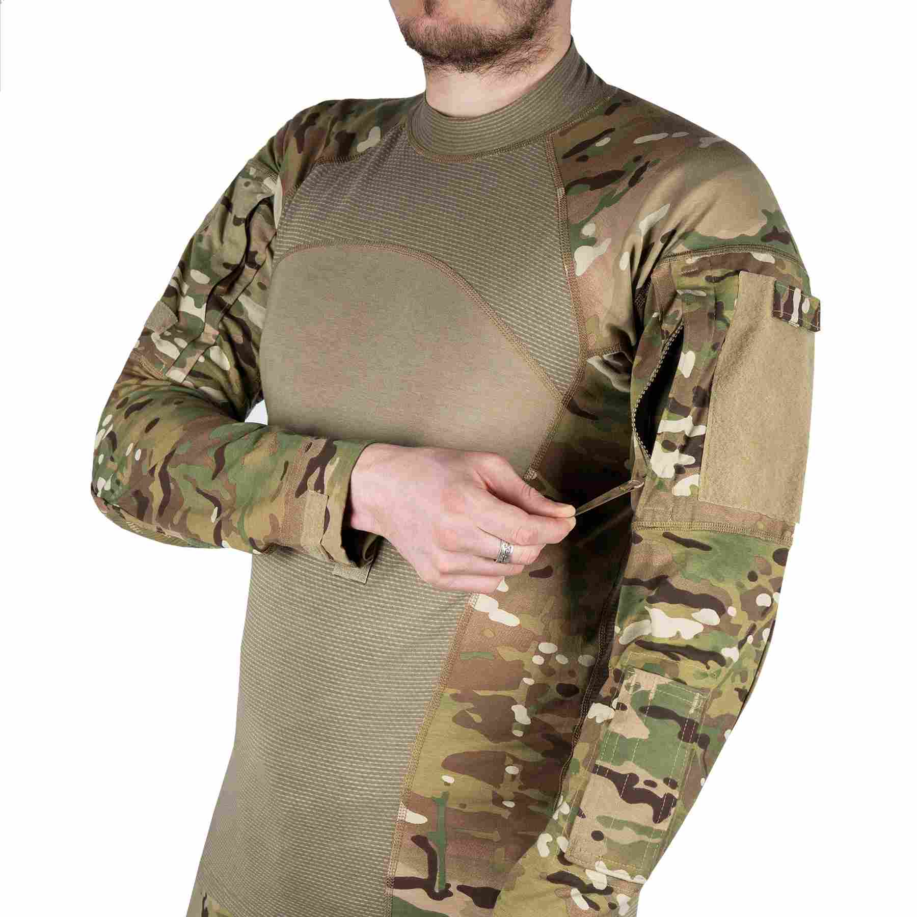 A person in a tactical combat shirt with long sleeves, unfastening a pocket on the sleeve by hand